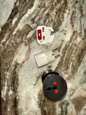 Universal Travel Plug Adapter Set - one black and 2  white (3 separate pieces)